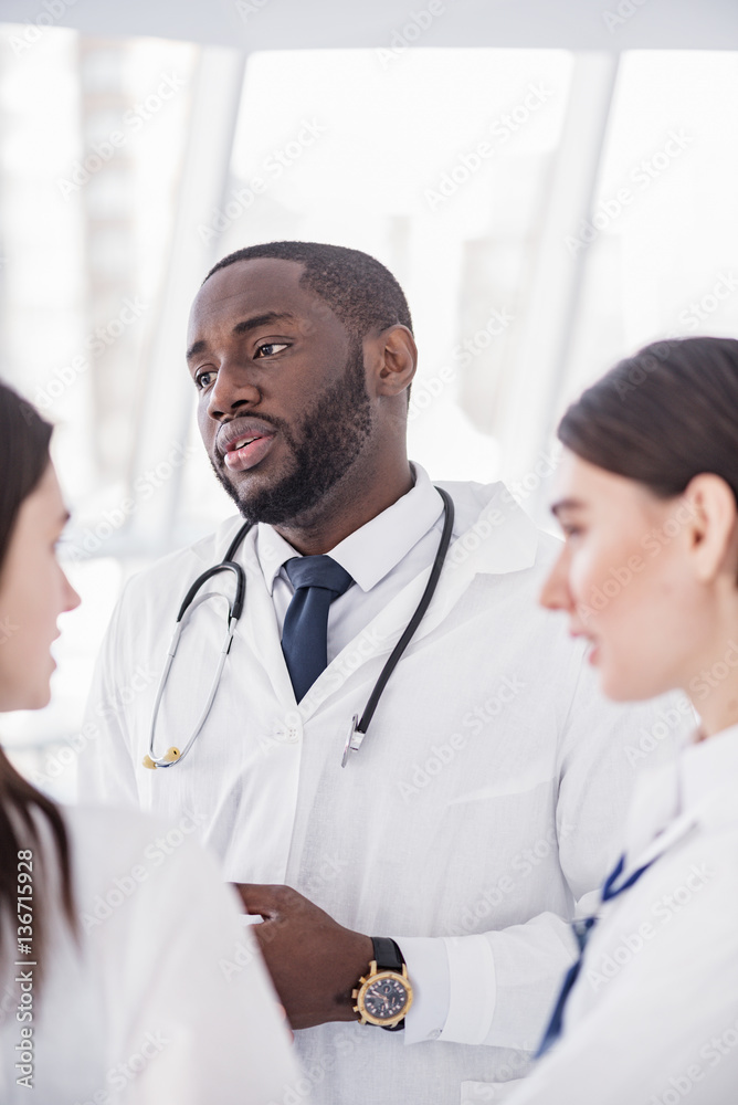 Serene medical advisers standing in clinic Serene medical advisers standing in clinic