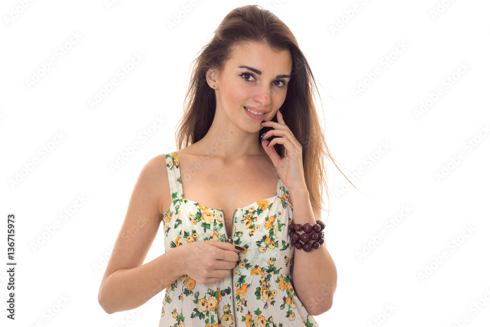 seductive young woman unbutton her sarafan with floral pattern and looking at the camera isolated on white background seductive young woman unbutton her sarafan with floral pattern and looking at the camera isolated on white background