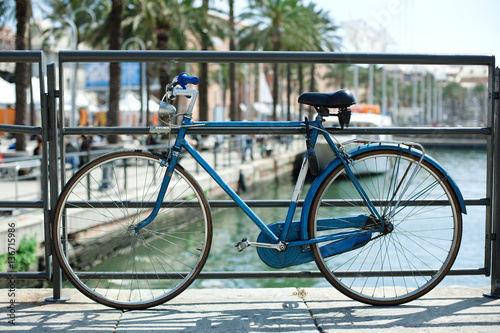 Blue bicycle near railing on a bridge