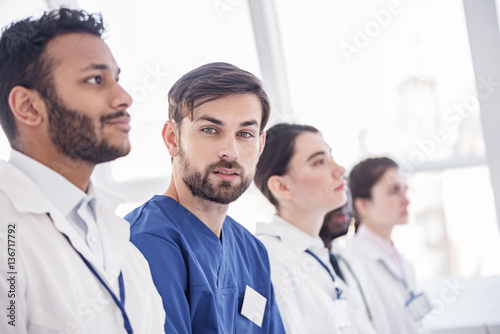 Calm physician locating at conference in room of clinic