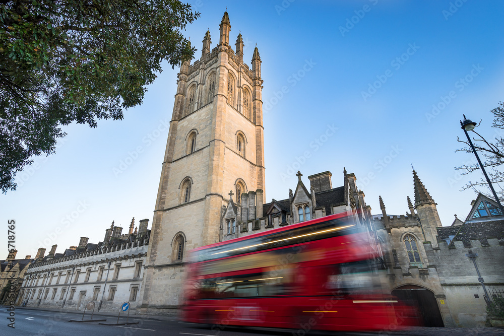 Obraz premium Magdalen College, Oxford and blurry red double decker bus.