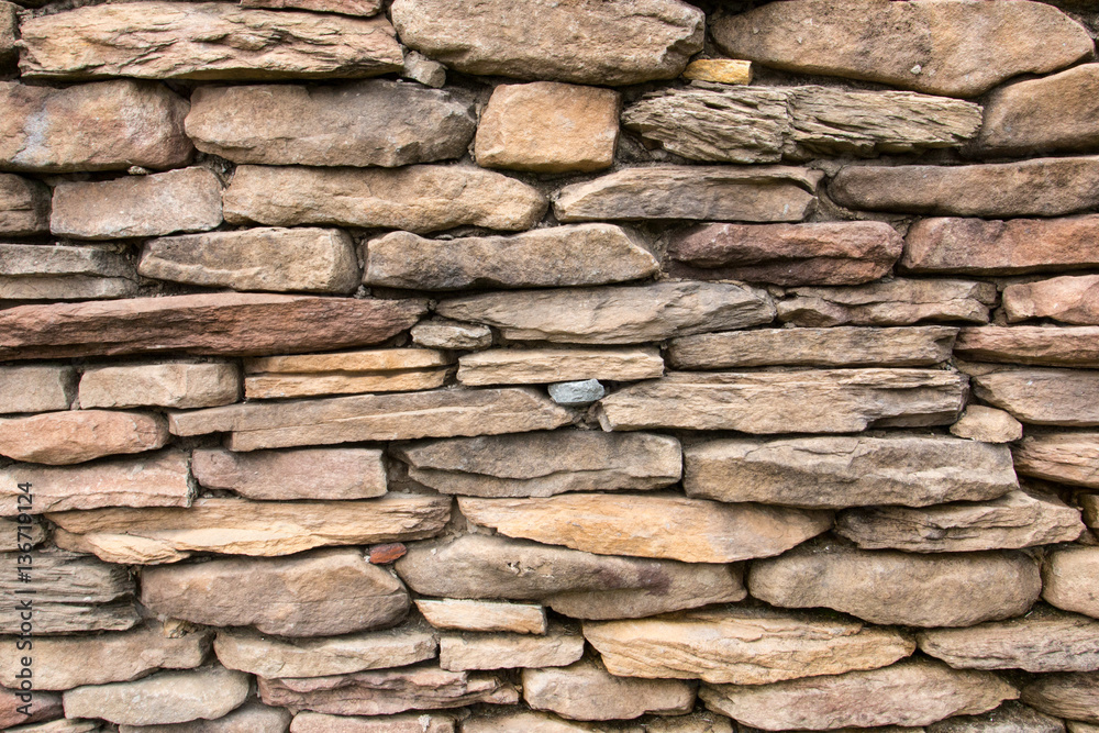 Fototapeta premium Stone wall fence for use as a background.