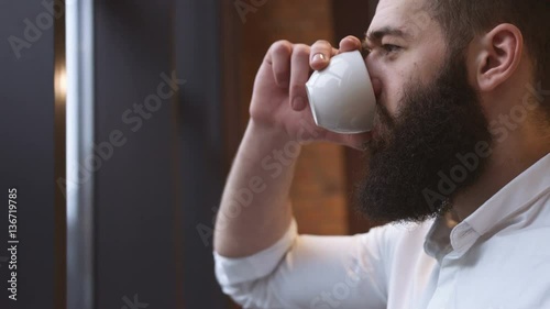 Young man drinking coffee in cafe