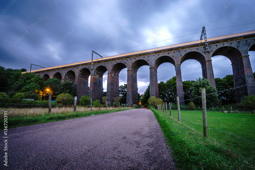 Old railway viaduct with blue sky. Long exposure