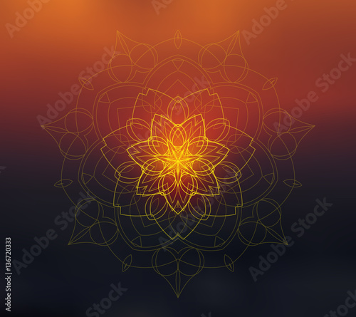 Shiny floral mandala on sunset blurred background