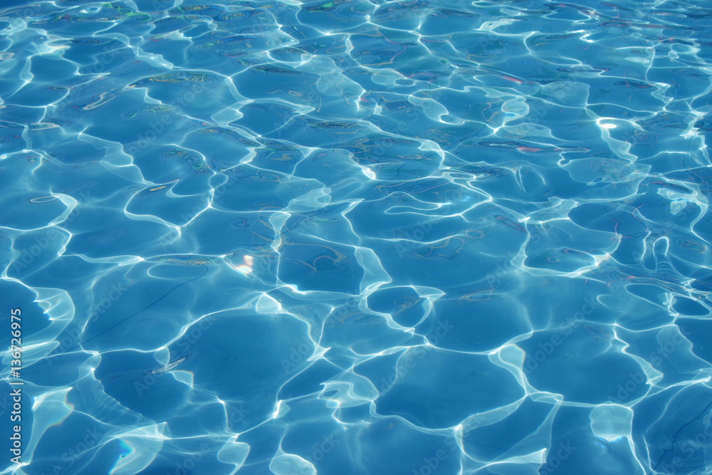 Fototapeta premium Blue romantic rippling water surface with sun glare