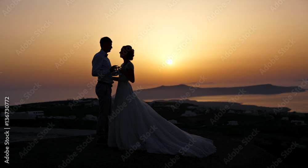Newlyweds at sunset.