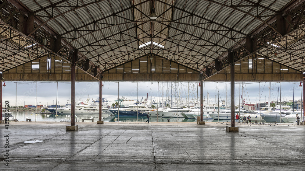 Beautiful view of the Port of Valencia, Spain, through an open industrial building