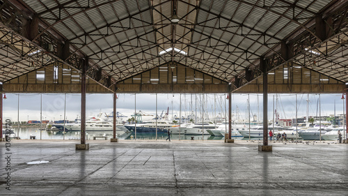 Beautiful view of the Port of Valencia  Spain  through an open industrial building
