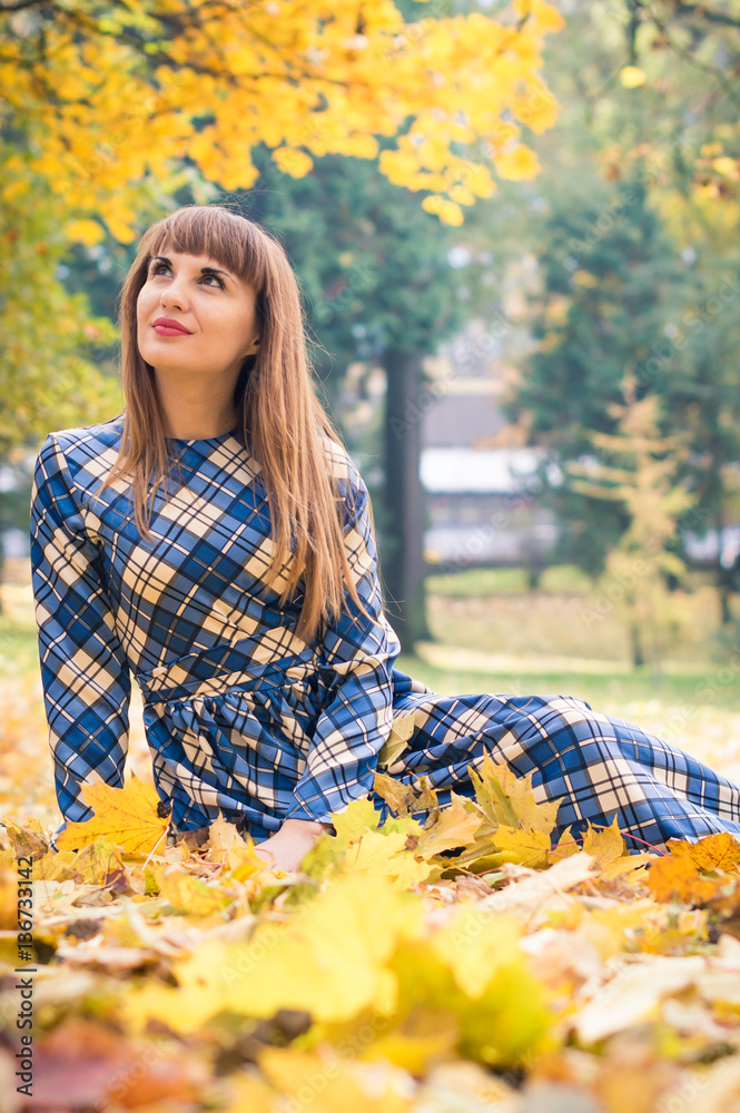 beautiful, dreamy girl with long straight hair in a blue long dress in the park in autumn beautiful, dreamy girl with long straight hair in a blue long dress in the park in autumn