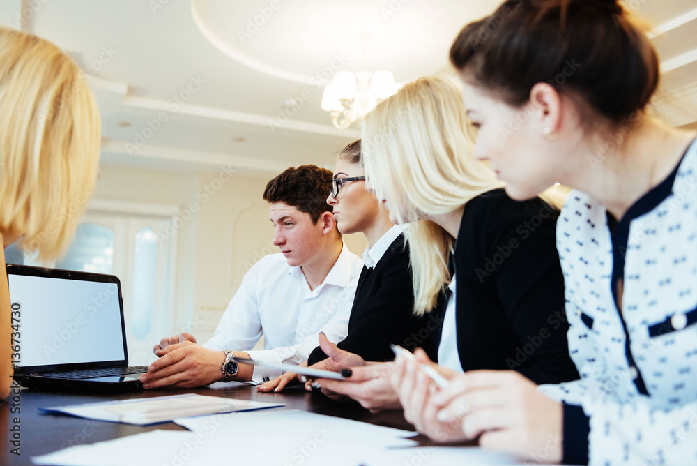 Group of students studying using a laptop