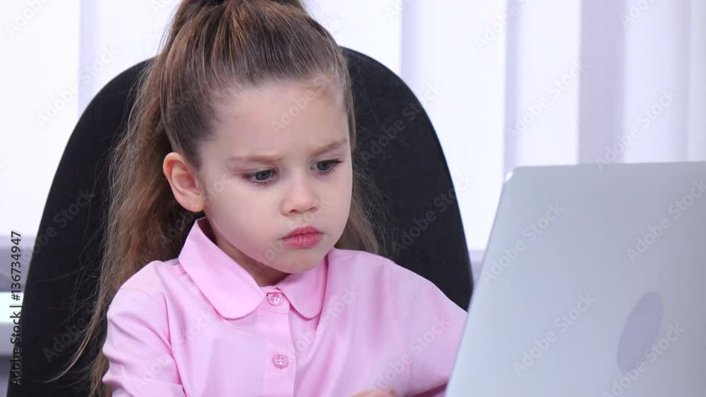 Little girl head looking at laptop and talking with her little slave Little girl head looking at laptop and talking with her little slave