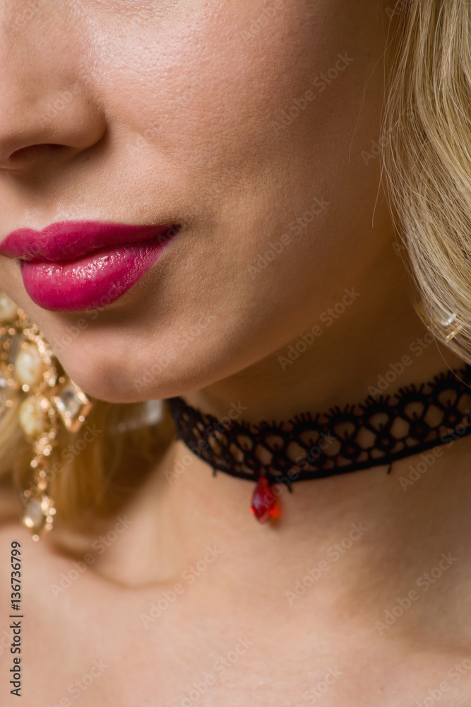 Beautiful woman showing her neck with a choker on it