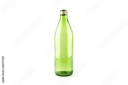 Glass empty green bottle isolated on a white background