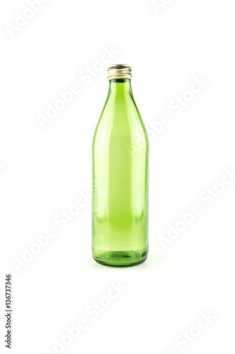 Glass empty green bottle isolated on a white background