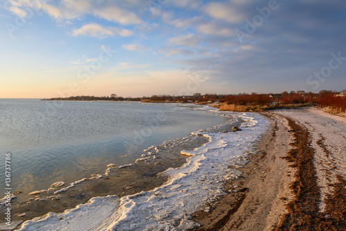 Frozen coastline in Jastarnia at sunset time. Baltic Sea. Poland.