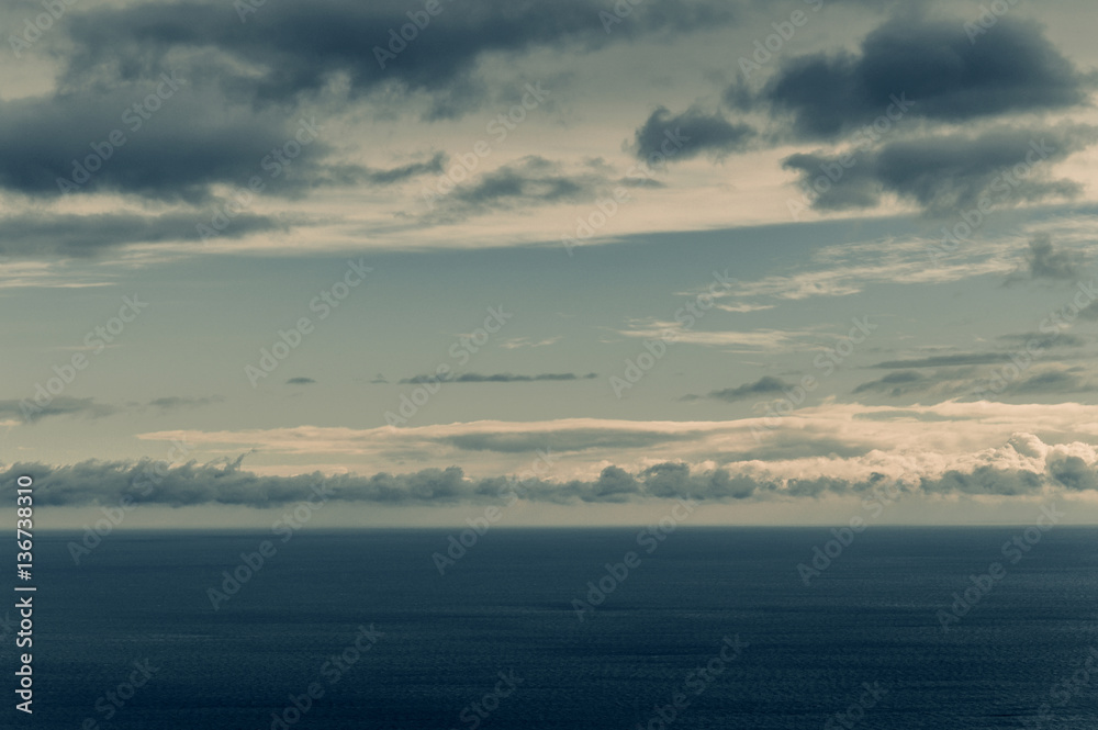 Beautiful and terrible horizon of the black sea with dark clouds