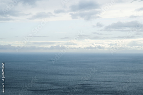 An endless horizon of the sea with clouds