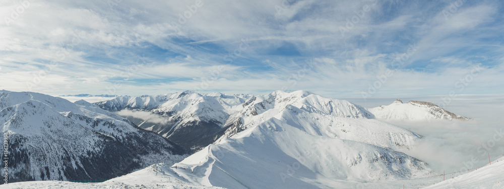Panorama of top of high mountains in winter, covered by snow. Tatra mountains