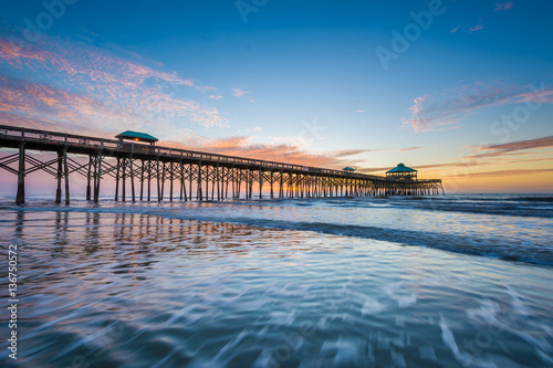 Waves in the Atlantic Ocean and the pier at sunrise  in Folly Be
