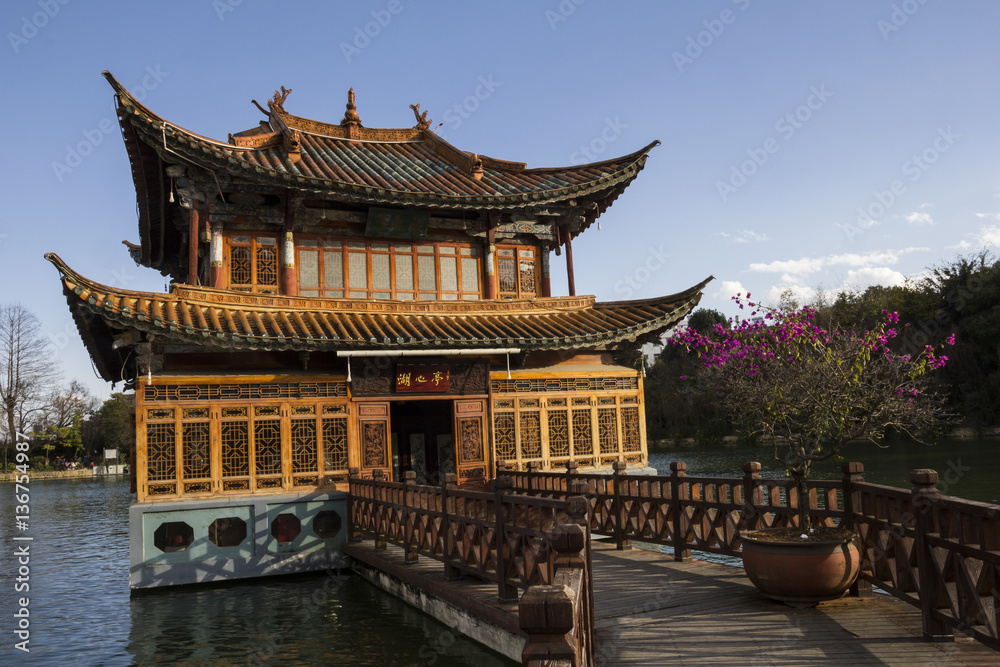 Traditional chinese wooden building with a pier on lake Traditional chinese wooden building with a pier on lake