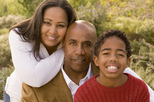 Portrait of happy multicultural family smiling. © digitalskillet1