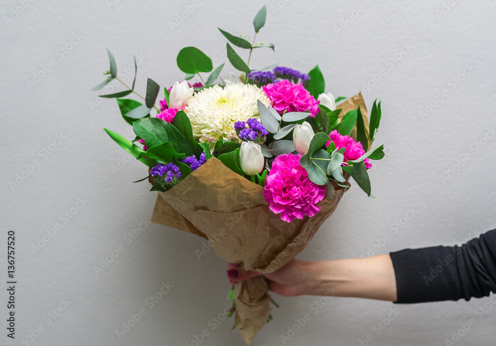 Woman hand holding flowers