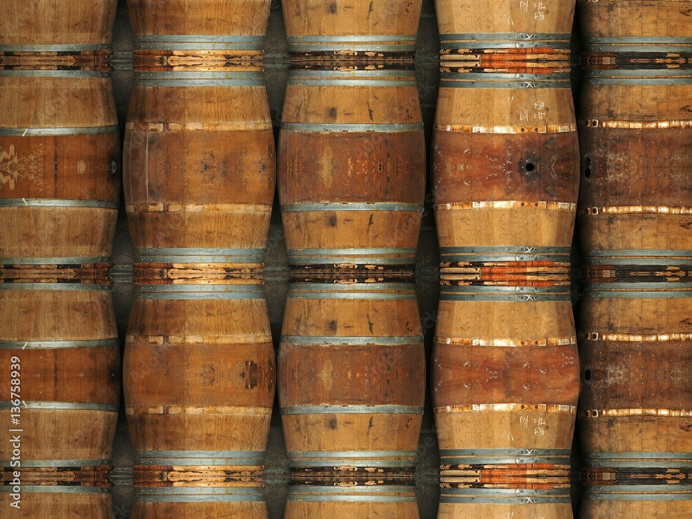 Wine barrels stacked in the cellar background