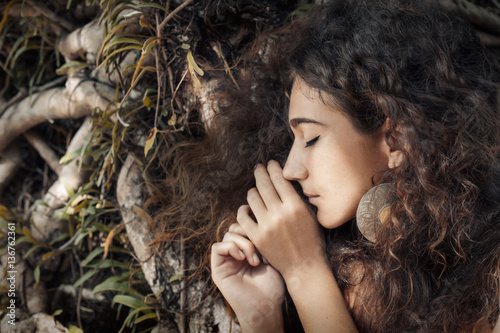 close up portrait of beatiful young girl at wooden roots background