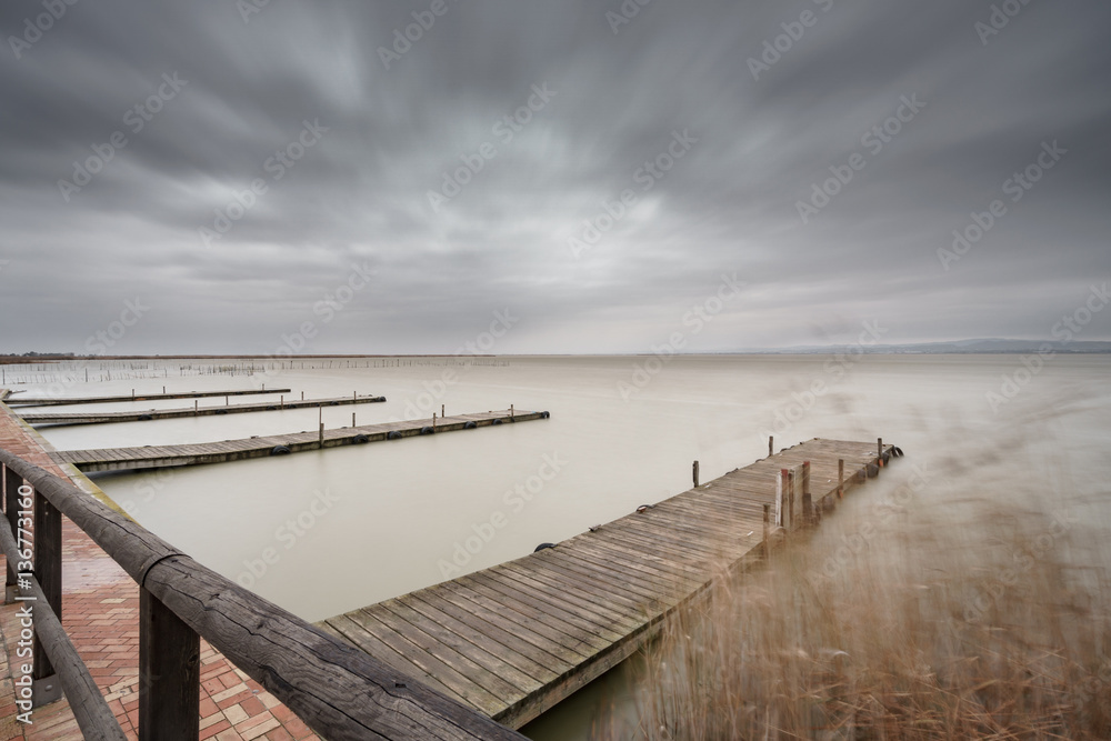 Storm over Albufera with piers in perspective, Valencia