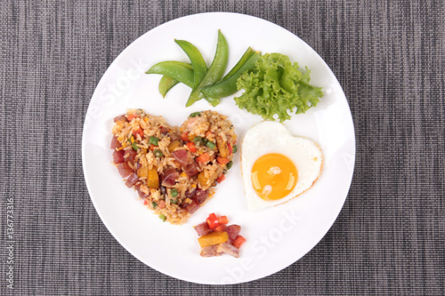 Chinese sausage fried rice and sunny egg in heart shapes.