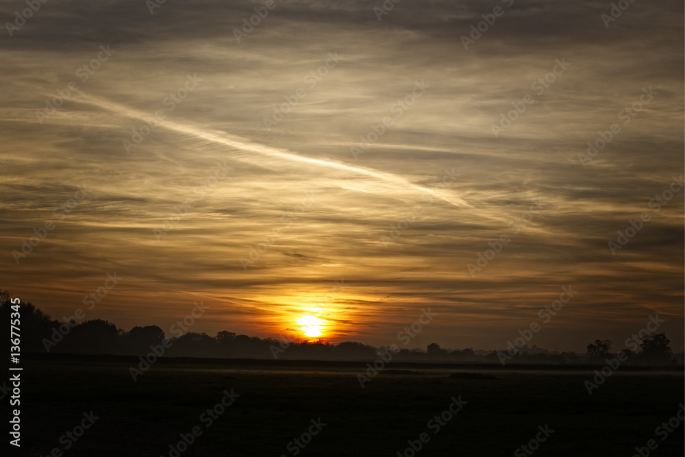 Sunset over farmland, Gloucestershire, England, UK.