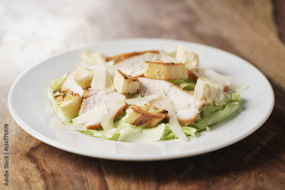 fresh simple caesar salad with chicken, shallow depth of field fresh simple caesar salad with chicken, shallow depth of field