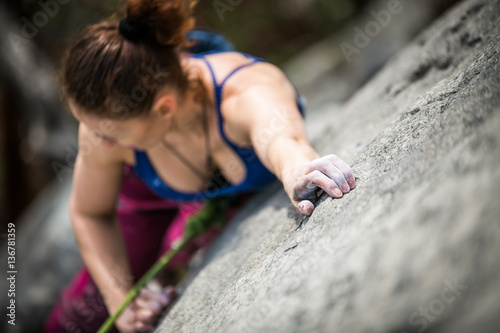 woman climbs a rock