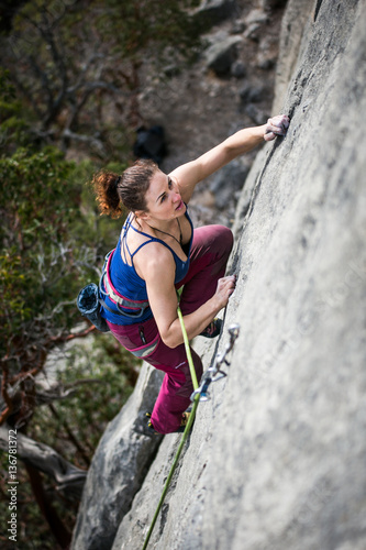 woman climbs a rock