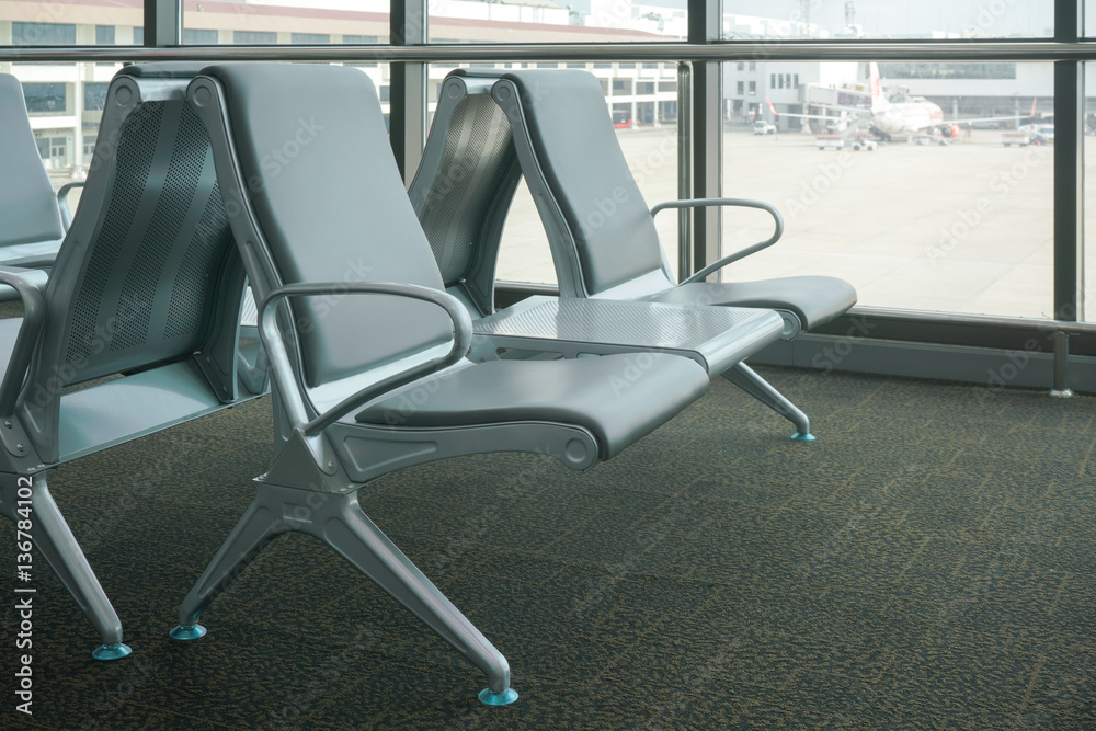 row of gray seats at airport terminal row of gray seats at airport terminal