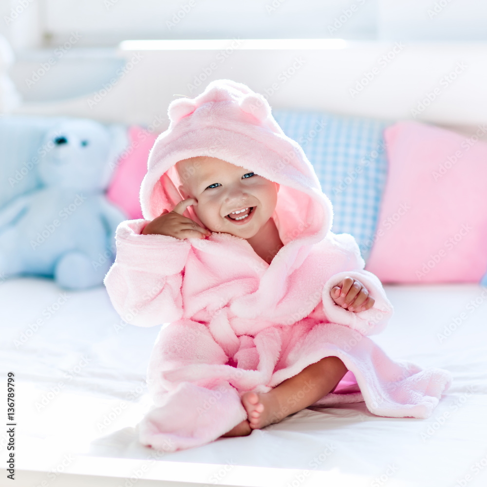 Baby in bathrobe or towel after bath foto de Stock Adobe Stock