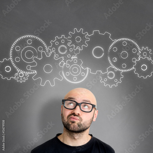 Gear wheel going out of the head of a young attractive thinking