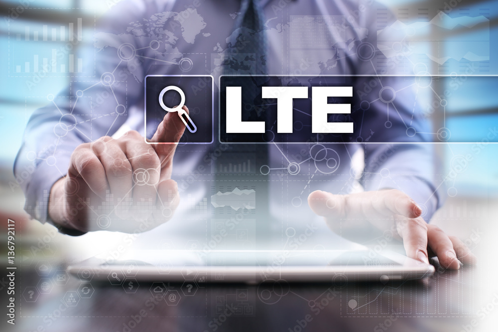 Fototapeta premium Businessman using tablet pc and selecting lte.