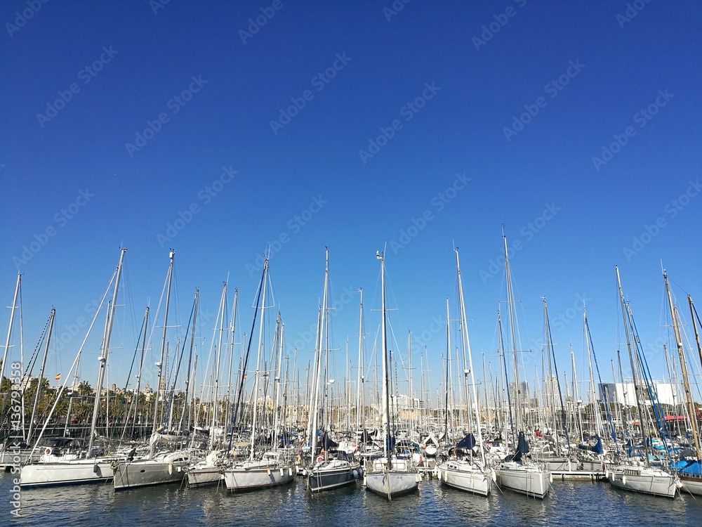 BARCELONA, SPAIN - FEBRUARY 9, 2017 : Sailboats parked in Barcelona harbour during a sunny day.