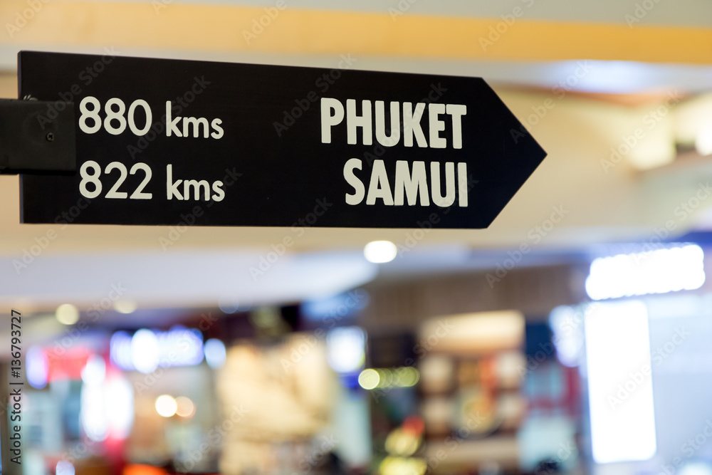 signpost with distances to holiday destinations in Phuket or Samui, airport in Bangkok, Thailand