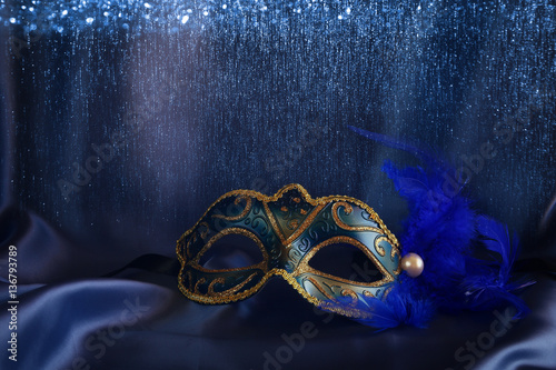 elegant venetian mask on blue silk background