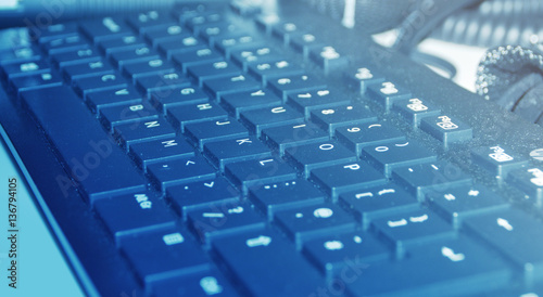 Dusty keyboard in blue light