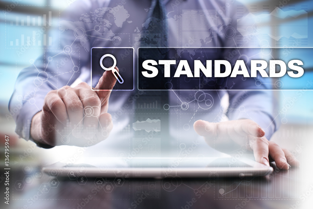 Fototapeta premium Businessman using tablet pc and selecting standards.