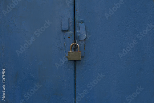 Closeup shot of metal blue door with a lock