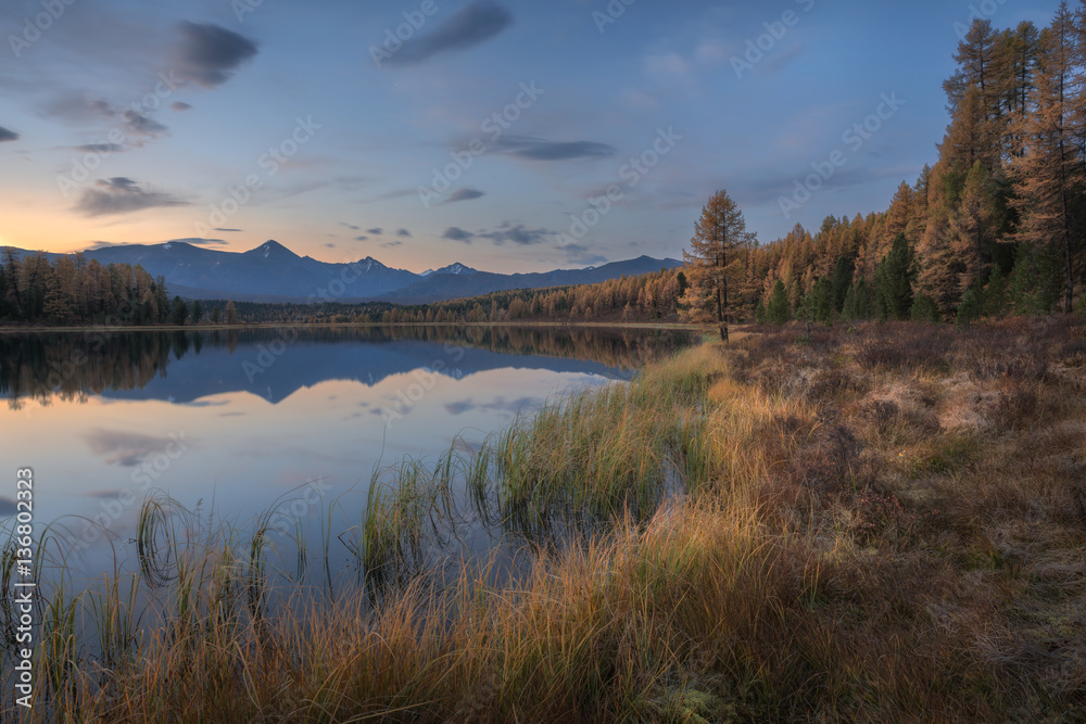 Mirror Surface Lake Autumn Landscape With Mountain Range On Background With Light Pink Sky
