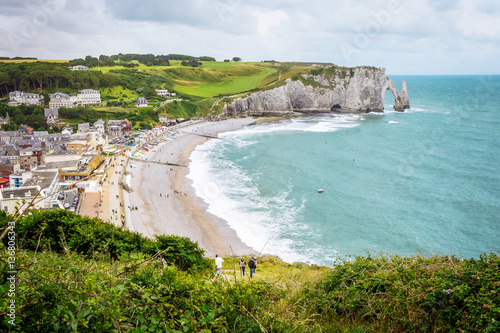 Fantastic white sand beach and cliffs of Etretat, norman french town outdoor landscape. View above the town and the bay of Falaise d'Amont Etretat City, famous landmark of Normandy in France, Europe