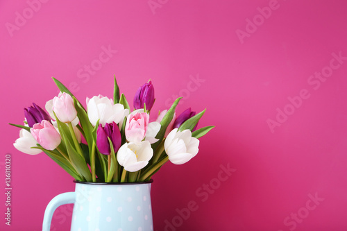 Fototapeta Naklejka Na Ścianę i Meble -  Bouquet of tulips in jug on pink background