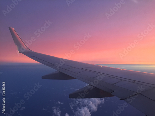 A view of an aircraft wing during sunset. Shot in landscape format.