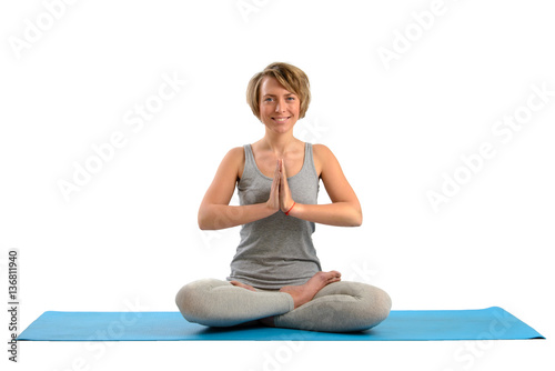 Young yoga woman meditating in the lotus position. Isolated on w